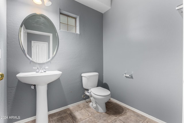 bathroom featuring tile patterned floors and toilet