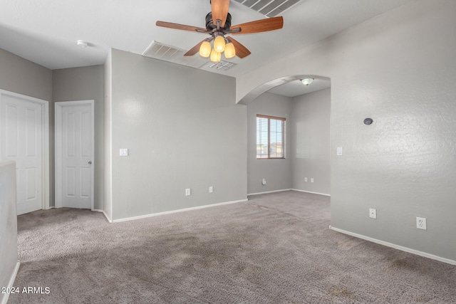 carpeted spare room featuring ceiling fan