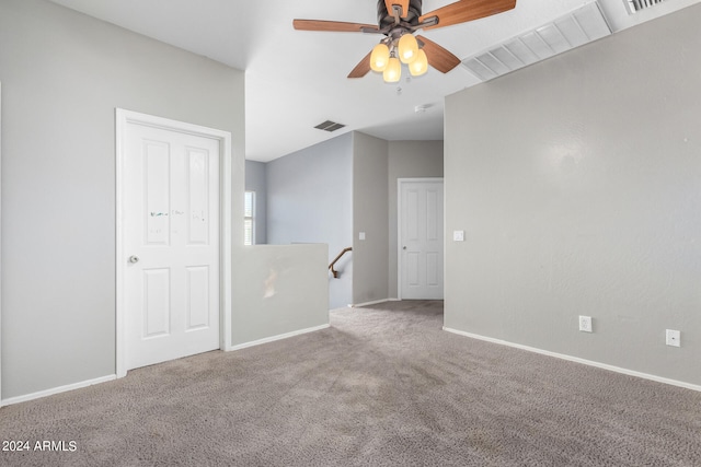 empty room with ceiling fan and carpet