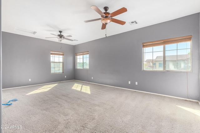 carpeted spare room with ceiling fan