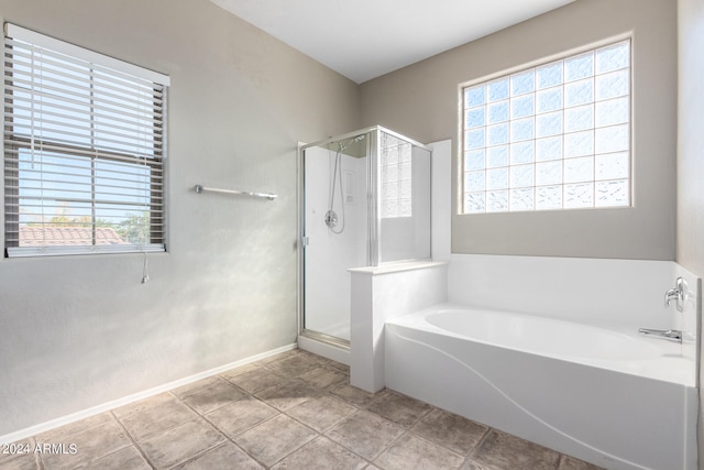 bathroom featuring a healthy amount of sunlight, tile patterned flooring, and independent shower and bath