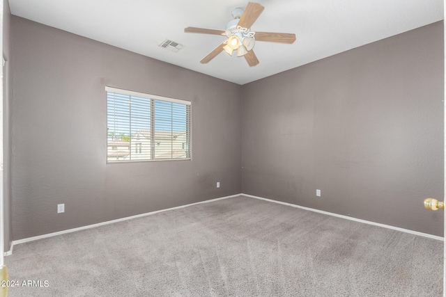 carpeted spare room with ceiling fan