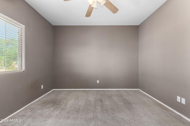 carpeted empty room featuring ceiling fan