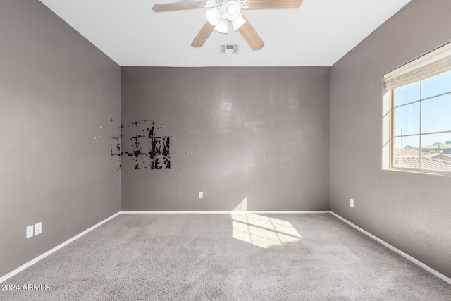 carpeted spare room with ceiling fan