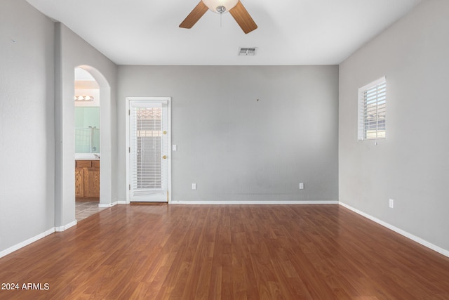 empty room with ceiling fan and wood-type flooring