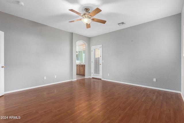 unfurnished room with ceiling fan and dark hardwood / wood-style flooring