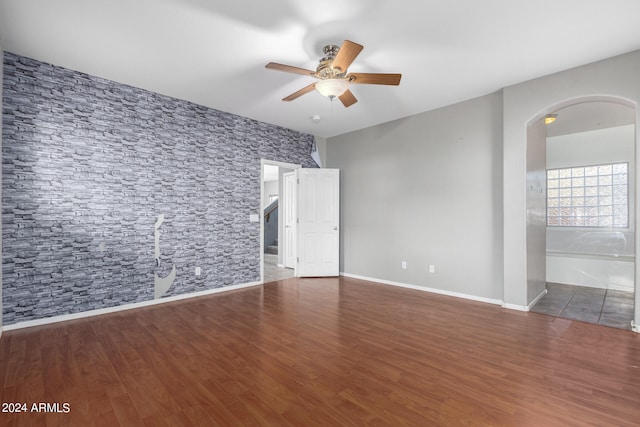 unfurnished room featuring ceiling fan and wood-type flooring