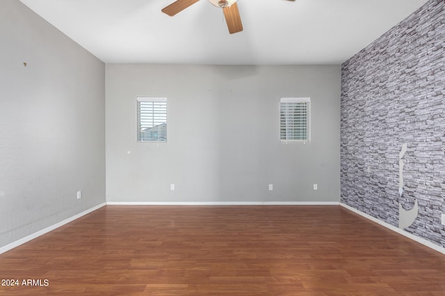 empty room featuring hardwood / wood-style flooring and ceiling fan