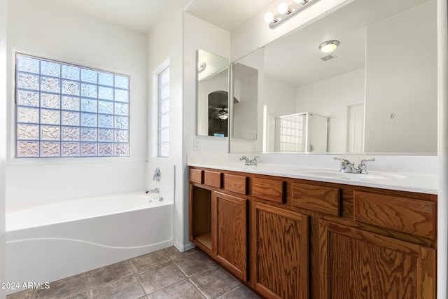 bathroom with tile patterned flooring, separate shower and tub, and vanity