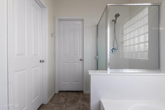 bathroom with walk in shower and tile patterned floors