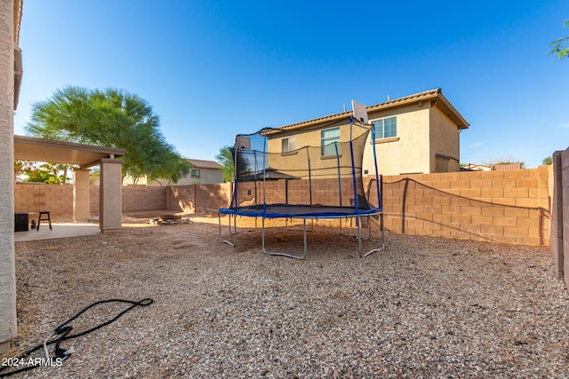 exterior space featuring a trampoline and a patio area