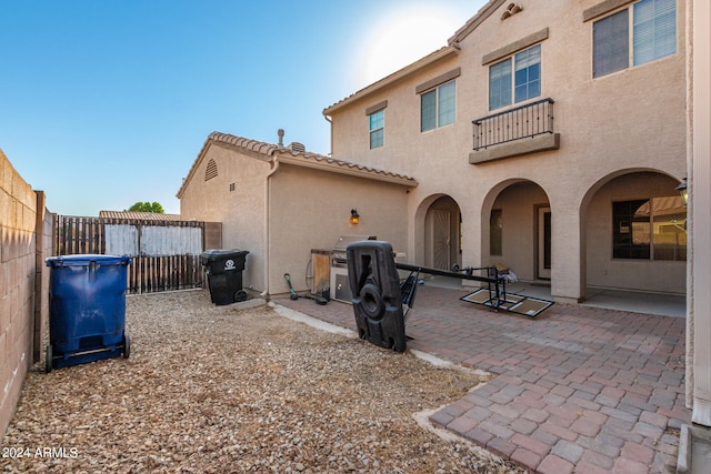 back of house with a balcony and a patio area