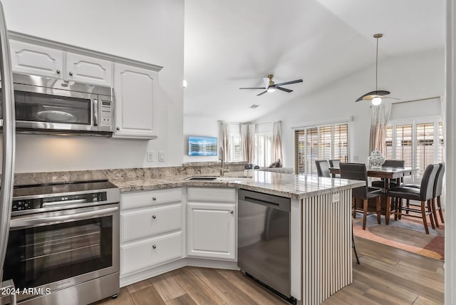 kitchen with white cabinets, kitchen peninsula, sink, and appliances with stainless steel finishes