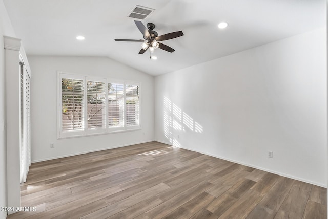 empty room featuring wood-type flooring, vaulted ceiling, and ceiling fan