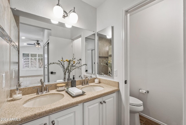 bathroom featuring wood-type flooring, vanity, toilet, and ceiling fan