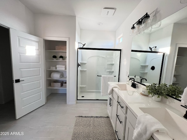 bathroom with a shower with shower door and vanity