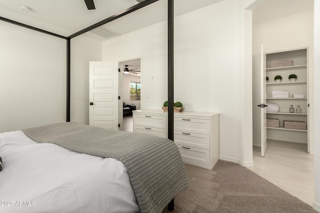 bedroom with ceiling fan and light carpet