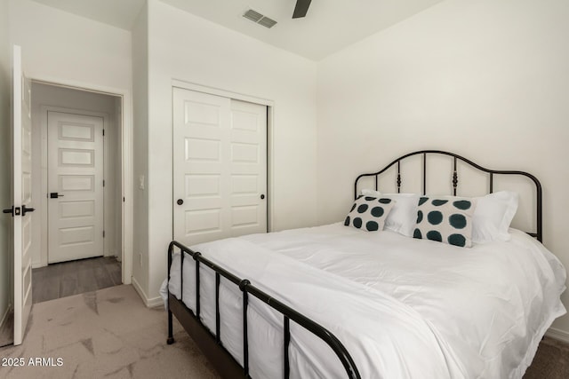 bedroom with ceiling fan, a closet, and carpet floors