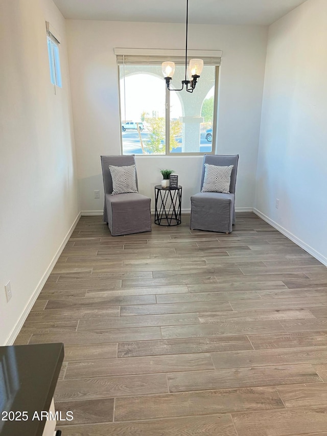 unfurnished room with light hardwood / wood-style floors and a chandelier