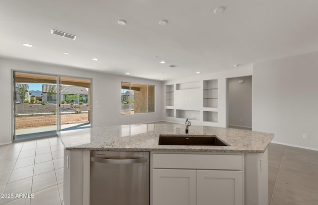 kitchen with built in features, visible vents, open floor plan, a sink, and stainless steel dishwasher