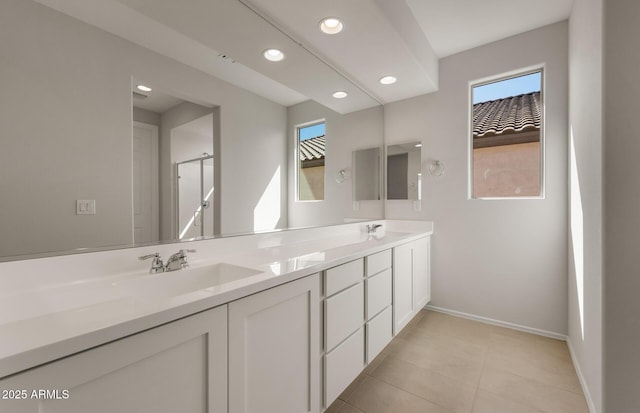 bathroom with double vanity, plenty of natural light, and a sink