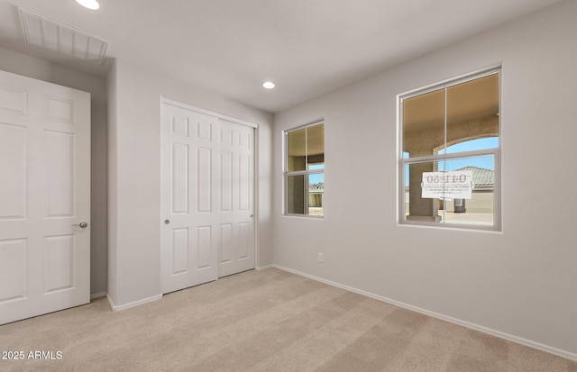 unfurnished bedroom with light carpet, recessed lighting, visible vents, and baseboards