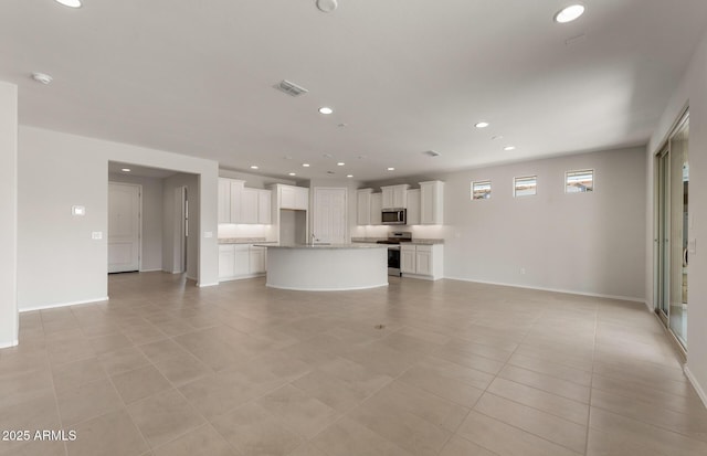 unfurnished living room with recessed lighting, visible vents, baseboards, and light tile patterned floors