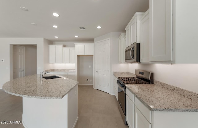 kitchen with white cabinetry, visible vents, stainless steel appliances, and a sink