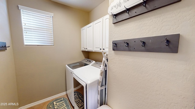 washroom featuring washer and clothes dryer and cabinets