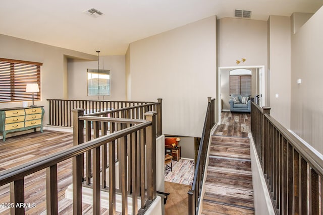 hallway featuring hardwood / wood-style flooring and vaulted ceiling