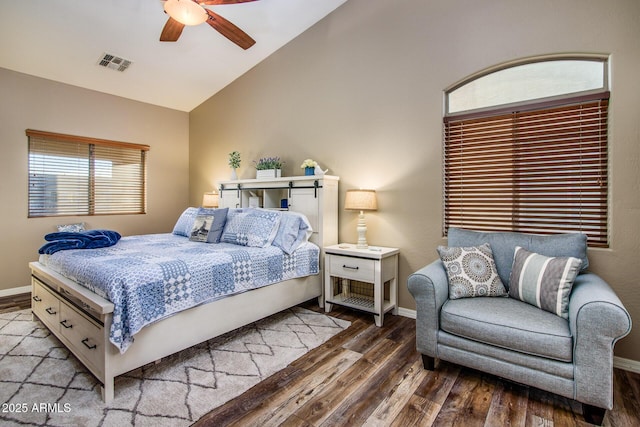 bedroom with ceiling fan, lofted ceiling, and hardwood / wood-style flooring