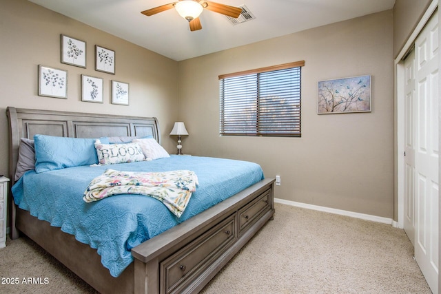 carpeted bedroom with ceiling fan and a closet