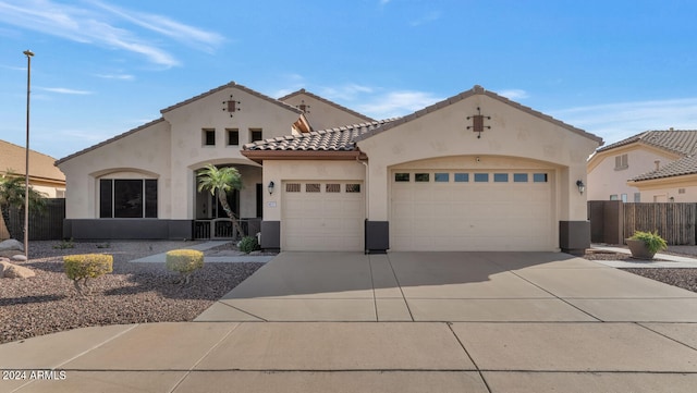 mediterranean / spanish-style house featuring central air condition unit and a garage