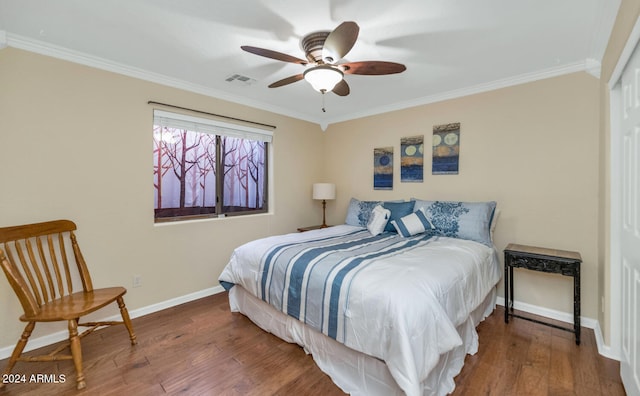 bedroom featuring ceiling fan, hardwood / wood-style floors, and ornamental molding