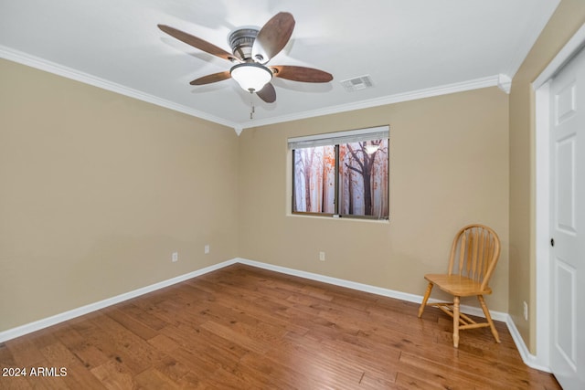 unfurnished room with wood-type flooring, ceiling fan, and ornamental molding