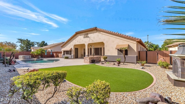 rear view of house featuring a lawn, a fenced in pool, and a patio