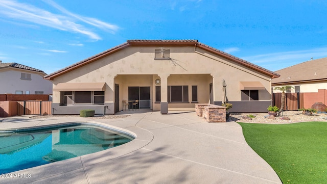 back of house featuring a fenced in pool and a patio area