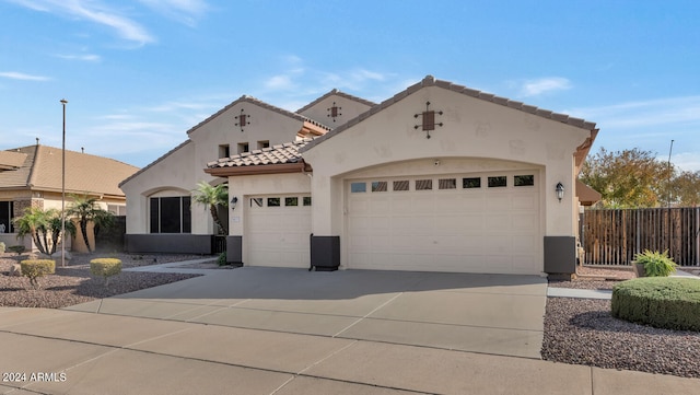 mediterranean / spanish-style home with a garage