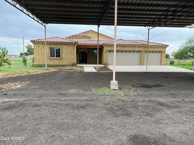 view of front of house with a carport and a garage