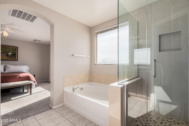 bathroom featuring tile patterned flooring, ceiling fan, and plus walk in shower