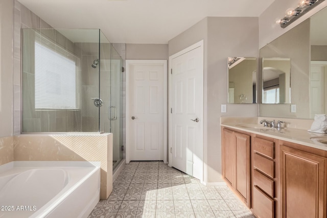 bathroom featuring shower with separate bathtub, vanity, and tile patterned floors