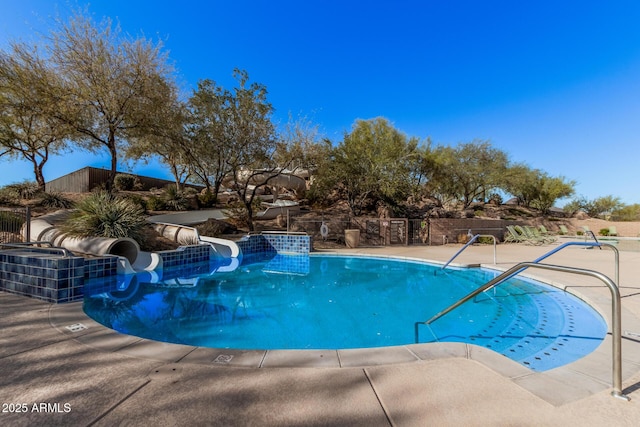 view of pool featuring a patio and a water slide