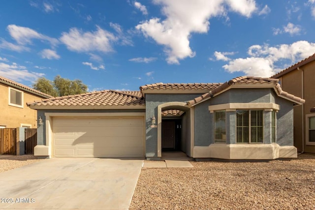 mediterranean / spanish-style home with a garage