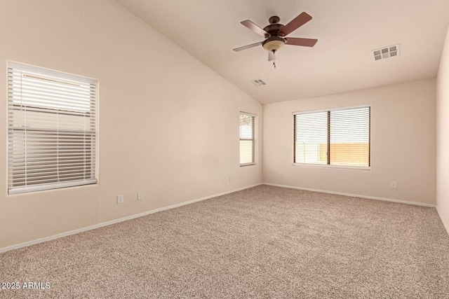 carpeted spare room featuring ceiling fan and lofted ceiling