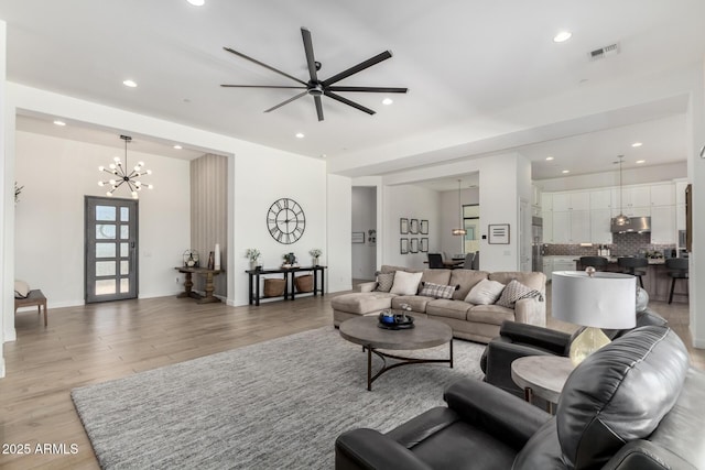 7002 S Portland Ave, Gilbert, AZ 85298 - living area with recessed lighting, light wood-type flooring, a ceiling fan, and a chandelier