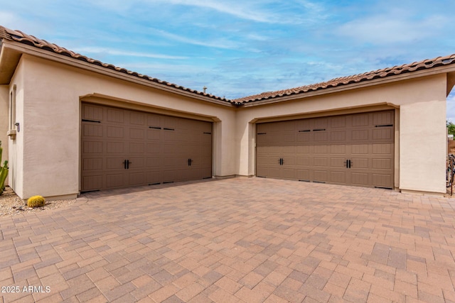 garage with decorative driveway