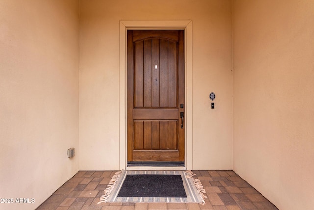 property entrance with stucco siding