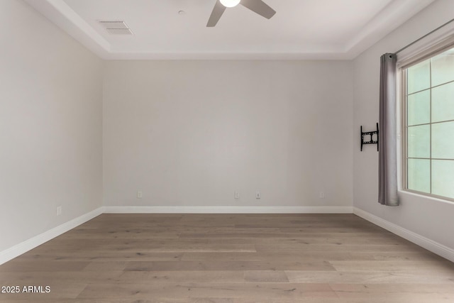 empty room with plenty of natural light, visible vents, and light wood-type flooring