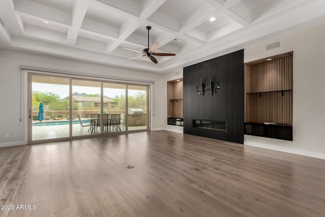 unfurnished living room featuring wood finished floors, baseboards, coffered ceiling, and ceiling fan