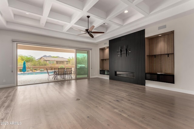 unfurnished living room with wood finished floors, baseboards, ceiling fan, and coffered ceiling
